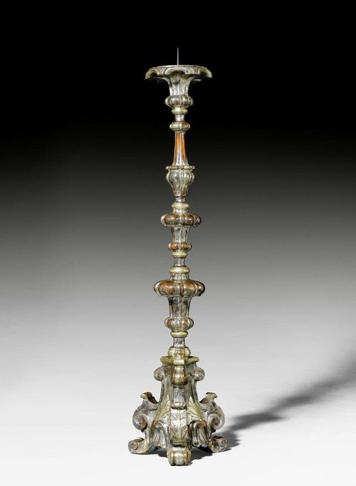 TALL CANDLEHOLDER,Baroque, German, 18th century. Shaped and carved wood with remains of old silvering. Iron spike. H 143 cm.
