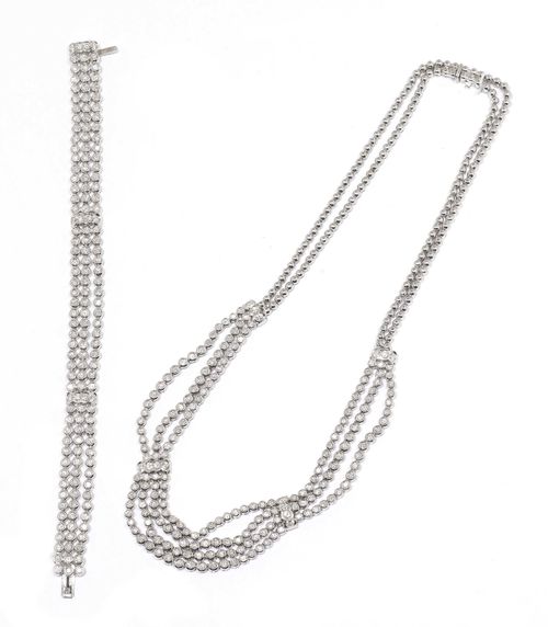 DIAMOND NECKLACE WITH  BRACELET. White gold 750, Casual-elegant Rivière necklace with double bead chain, the three-row front set with numerous brilliant-cut diamonds in round collet settings and additionally decorated with 4 barrette intermediate links. Total weight of the 180 brilliant-cut diamonds ca. 4.00 ct. L ca. 50 cm. Matching three-row bracelet with a total of 156 brilliant-cut diamonds weighing  ca. 3.50 ct. L ca. 18 cm.