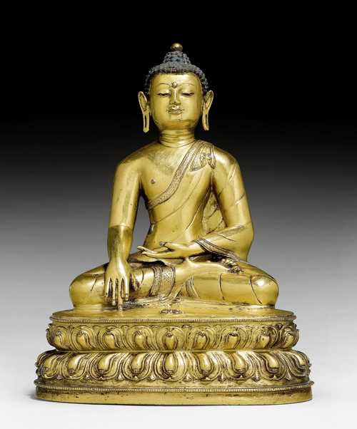A GILT COPPER ALLOY FIGURE OF BUDDHA WITH A VAJRA.