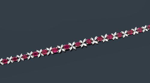 RUBY AND DIAMOND BRACELET, GÜBELIN, ca. 1960. White gold 750. Classic-elegant bracelet, set with 15 fine, oval rubies weighing ca. 9.00 ct, unheated, within a border of 60 navette-cut diamonds weighing ca. 4.50 ct. L ca. 17 cm. With case.