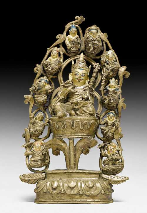 A BRONZE FIGURE OF PADMASAMBHAVA WITH EIGHT MANIFESTATIONS OF HIMSELF AND TWO DISCIPLES IN THE AUREOLE.