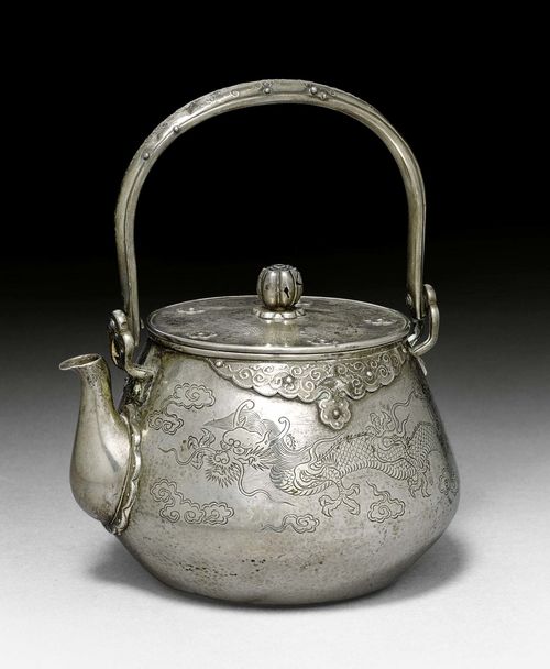 A SILVER TEA POT WITH CARVED DRAGONS. Japan, Meiji period, height 16.5 cm.