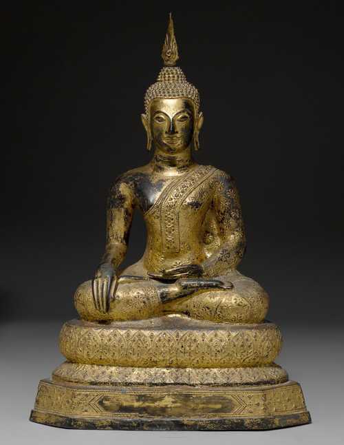 A LACQUER-GILT BUDDHA SEATED ON A LOTUS THRONE.