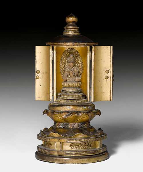 A ROUND ZUSHI OF THE ELEVEN HEADED KANNON SEATED ON A LOTUS.