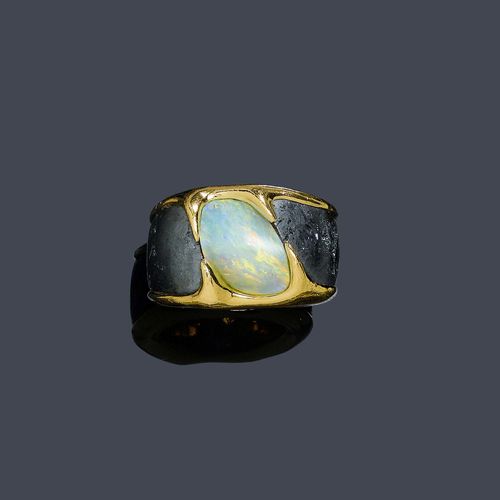 A HEMATITE AND OPAL RING, PH. PFEIFFER. Yellow gold 750. Set with a white opal of ca. 13 x 10 mm. Size ca. 56. With sales receipt, July 2001.