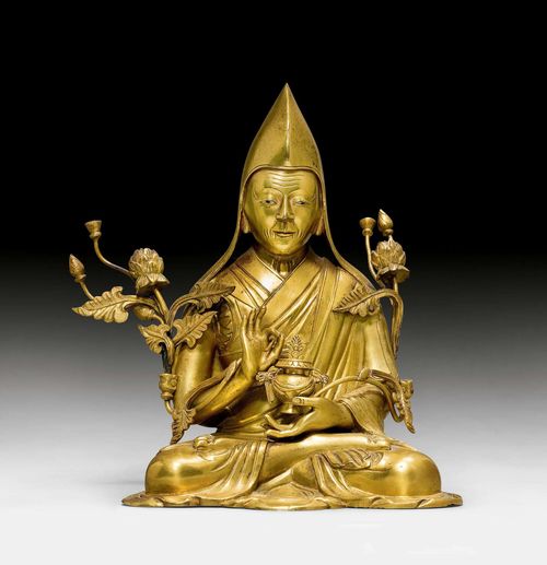 A GILT BRONZE FIGURE OF A HIGH RANKING MONK OF THE GELUGPA. Tibet, 18th/19th c. Height 15 cm. Minor damage.