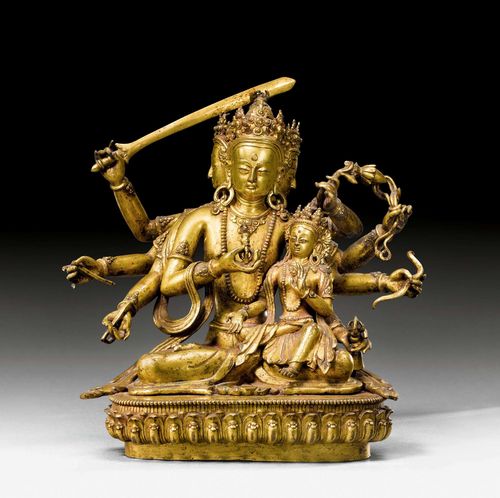 A GILT COPPER FIGURE OF DHARMADHATU VAGISHVARA MANJUSHRI WITH HIS CONSORT. Nepal, dated 1690, height 22.5 cm. Consecration plate lost.