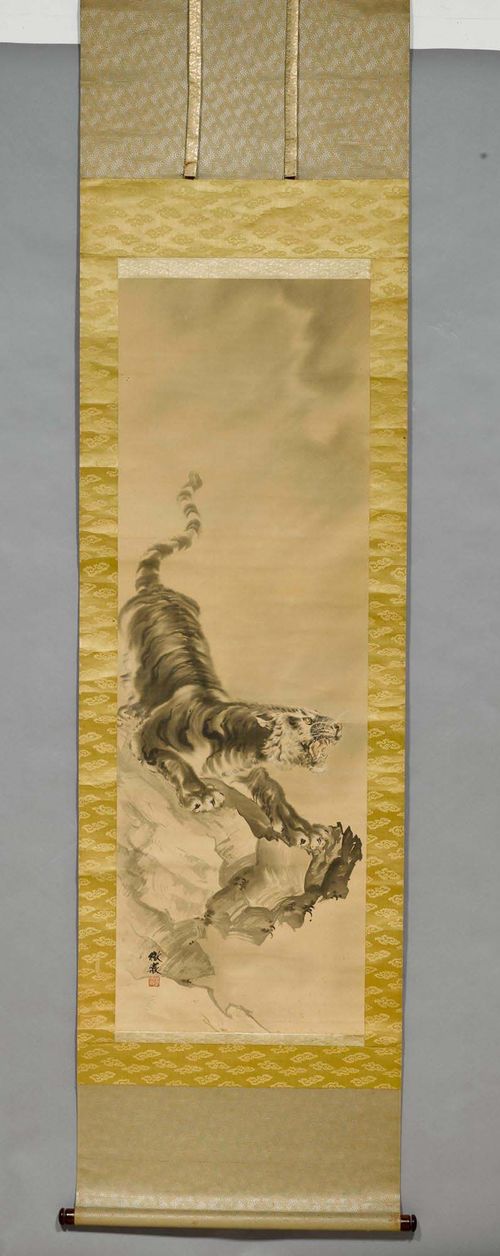 A HANGING SCROLL OF A SNARLING TIGER ON A ROCK. Japan, Meiji period, 125x42 cm. Ink, light colour and white on silk. Signature and seal. Silk mounting. Wood box.