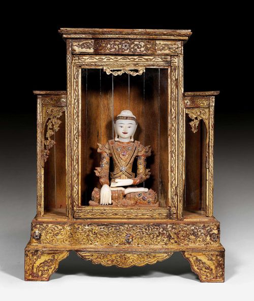 A RICHLY ADORNED MARBLE AND DRY LACQUER BUDDHA WITH ALTAR CABINET. Burma, Mandalay, around 1900. Buddha with crown: height 40.5 cm, cabinet: 61x35x78 cm.