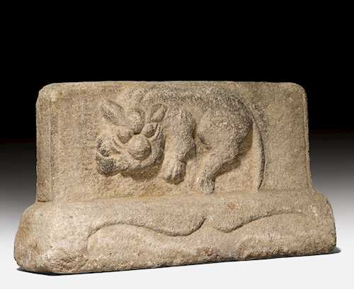 A GREY STONE RELIEF CARVED WITH A MYTHICAL BEAST.