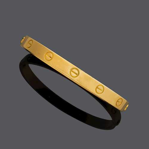 GOLD BANGLE, BY CARTIER.