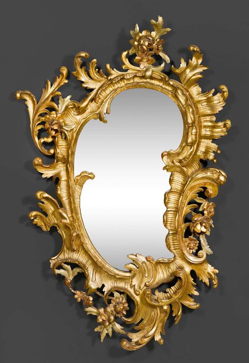 CARTOUCHE MIRROR,Baroque, German, 18th century. Heavily carved, gilt and partly painted wood. H 115 cm, W 71 cm.