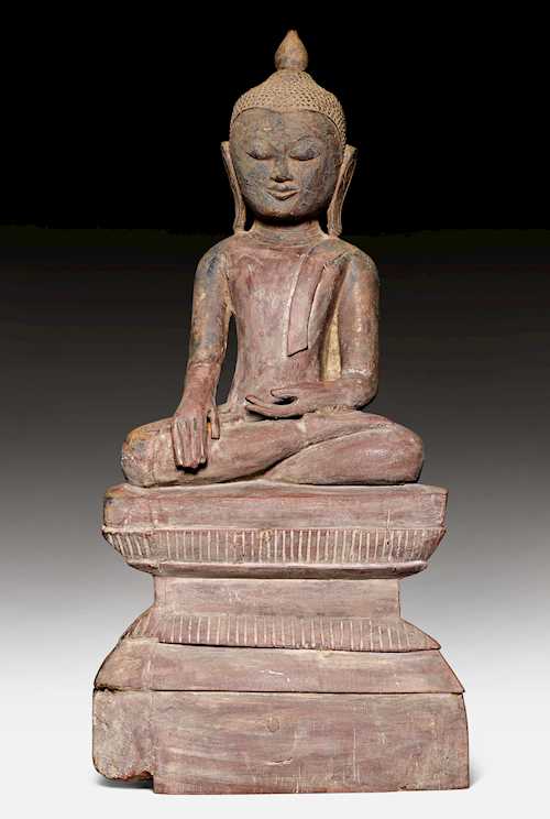 A WOODEN FIGURE OF THE SEATED BUDDHA, THE HANDS IN THE EARTH-TOUCHING MUDRA.
