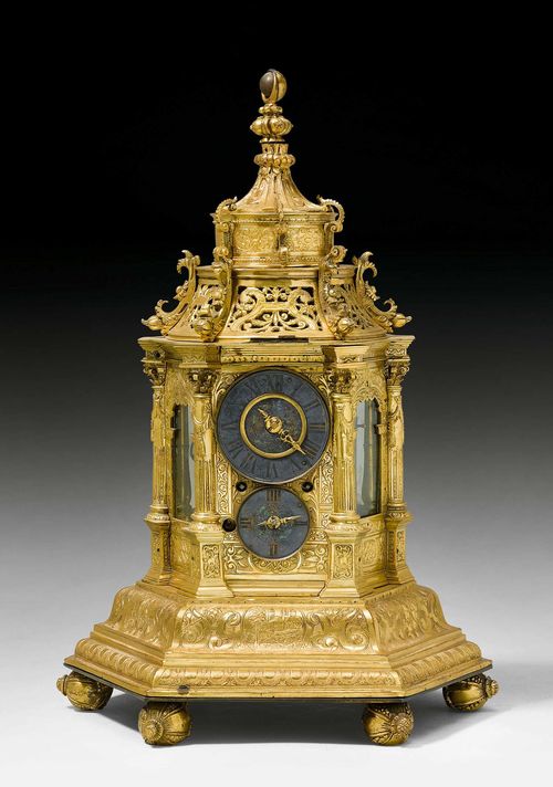 LARGE TURRET CLOCK,Renaissance and later, probably Augsburg. Matte and polished gilt bronze. The front with silver-plated chapter ring for the hours above dial for the minutes. Fine bronze hands. Verso with 2 small dials, probably formerly for alarm setting, but without function. Associated verge escapement with chain winding and striking on bell. Requires servicing. Some losses. 30x30x43 cm.