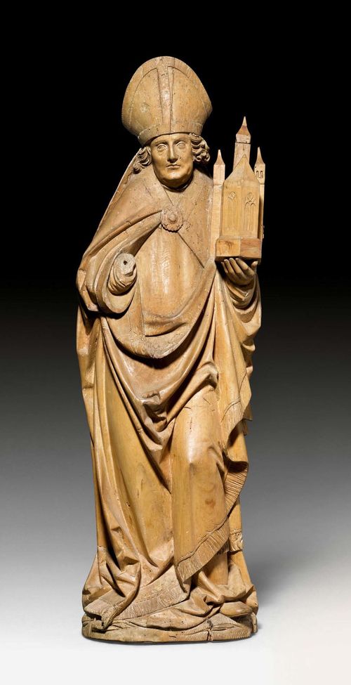 FIGURE OF A BISHOP WITH CHURCH MODEL,probably representation of Saint Wolfgang, late Gothic, Franconia circa 1500. Carved limewood, hollowed verso. The paint removed, right hand missing, the left supplemented. Supplements to the church towers. Wormholes in the plinth area. H 103 cm.