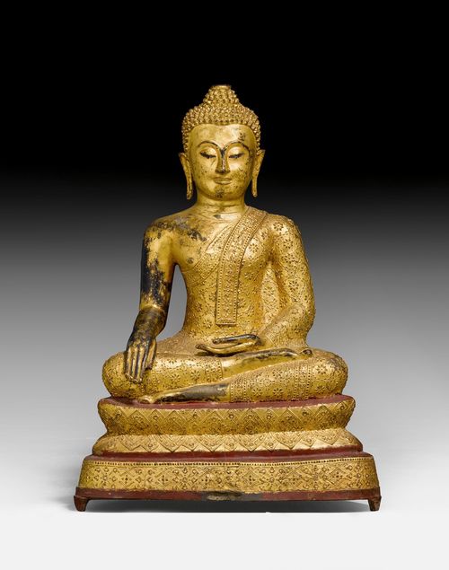 A RED AND GOLD LACQUERED BRONZE FIGURE OF THE BUDDHA MARAVIJAYA.