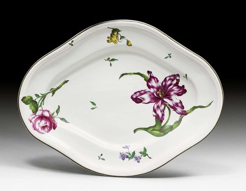 FAIENCE PRESENTOIR 'FLEURS FINES',Strasbourg, Joseph Anton Hannong period, circa 1763. A tureen stand. With free-painted flowers, probably using templates from the portfolio of Paul Hannong. Brown edge. Marked JH/207 in blue, 74 in black. D 38 cm. Minor retouching at the edge.