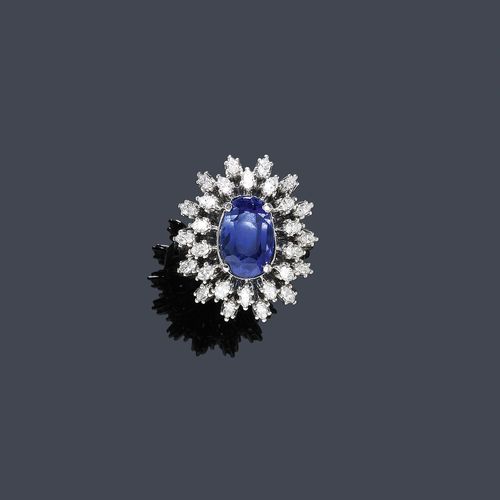 SAPPHIRE AND DIAMOND RING, PAUL GERHARD HARTKOPF, ca. 1950. White gold 750. Classic-elegant ring, the top set with 1 oval sapphire of ca. 5.00 ct, within a border of 28 navette-cut diamonds weighing ca. 1.50 ct. Size ca. 54. Matches the previous lot.