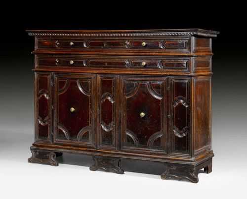 CREDENZA,Renaissance, Mantua circa 1620. Shaped and carved cherry and walnut. Rectangular structure with hinged top. The front with double doors below 2 narrow drawers, the top drawer as dummy and hinged. Bronze mounts and knobs. 184x55x135 cm. Provenance: - Formerly in the collection of the Marchese Lanza di Ajeta, Italy. - Formerly Lepke auction Berlin, 20.3.1928 (Lot No. 102).
