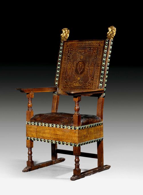 LARGE ARMCHAIR,Renaissance, Tuscany, circa 1580. Moulded walnut. The backrest with gilt corner cartouches. Fine leather cover with embossed coat of arms and decorative nailwork. 69x48x56x140 cm.