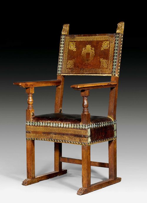ARMCHAIR,Renaissance, Tuscany, circa 1580. Shaped walnut. The backrest with gilt corner palmettes. Brown, gold-stamped leather cover with decorative nailwork. 63x44x54x127 cm.