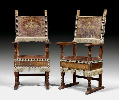 PAIR OF ARMCHAIRS,Renaissance, Tuscany, circa 1580. Shaped walnut. The backrest with gilt corner palmettes. Brown, gold-stamped leather cover with monogram and decorative nailwork. 67x44x58x138 cm.