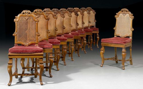 SET OF 10 CHAIRS "A LA REINE",Baroque, German, probably Ansbach circa 1750. Shaped and finely carved walnut. Caned. Wine red seat cushion. Restorations and supplements. 46x42x50x105 cm. Provenance: - Private collection, Switzerland. - Koller Zurich auction, 8.12.2011 (Lot No. 1205). - From a German collection.