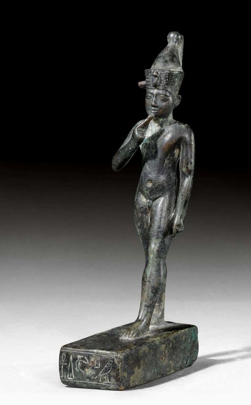 BRONZE  FIGURE OF HARPOCRATES,so-called "Horus as a Child", Egypt, 5th/3rd century BC. Bronze. Harpocrates standing with a double-crown of the united Lower and Upper Egypt, on a flat, rectangular base. Base with hieroglyphics. H 13.5 cm. Provenance: Austrian private collection, acquired in Vienna in the 1980s.