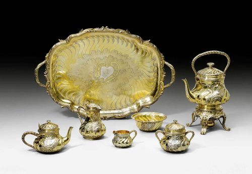 SILVER-GILT COFFEE AND TEA SERVICE,Paris, 1st half of the 19th century. Maker’s mark: Charles-Nicolas Odiot. Comprising: coffee pot, teapot, kettle-on-stand, cream jug, sugar bowl, confectionery dish and large tray with handles. H kettle-on-stand 38 cm, total weight 9675 g.