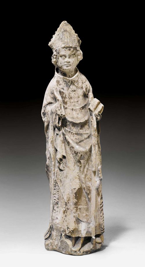 HOLY BISHOP,Gothic, Burgundy, end of the 14th century. Sandstone carved all around. The Saint with mitre, book and staff (incomplete), the right hand raised as a blessing. Weathered. H 63 cm. Provenance: From a private collection, Ticino.