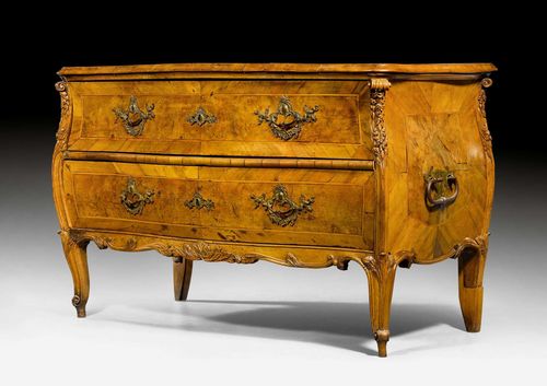 COMMODE,Louis XV, Central Germany, ca. 1760. Walnut and burlwood, finely carved with leaves and decorative frieze and inlaid with fillets and reserves. Front with 2 drawers, bronze mounts and handles. Requires restoration. Some losses. 125x63x82 cm. Provenance: From the collection of Ingeborg-Dorothée Freiin von Fürstenberg (Kettwig 1942-2013 Wiesbaden). I.D. Freiin von Fürstenberg was the daughter of Ferdinand Augustus Hubertus Maria von Fürstenberg in Schloss Hugenpoet and the aunt of the Baron von Fürstenberg.