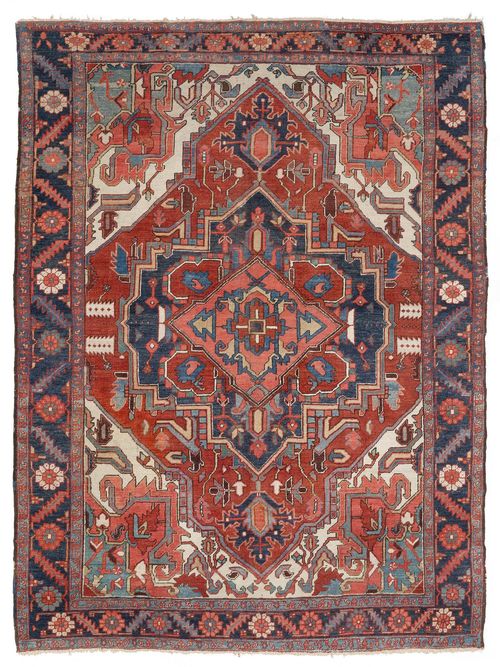 HERIZ antique.Blue and pink central medallion on a rust coloured ground with pink corner motifs, patterned with stylized plant motifs, dark blue edging, signs of wear, restored in some areas, 210x277 cm.