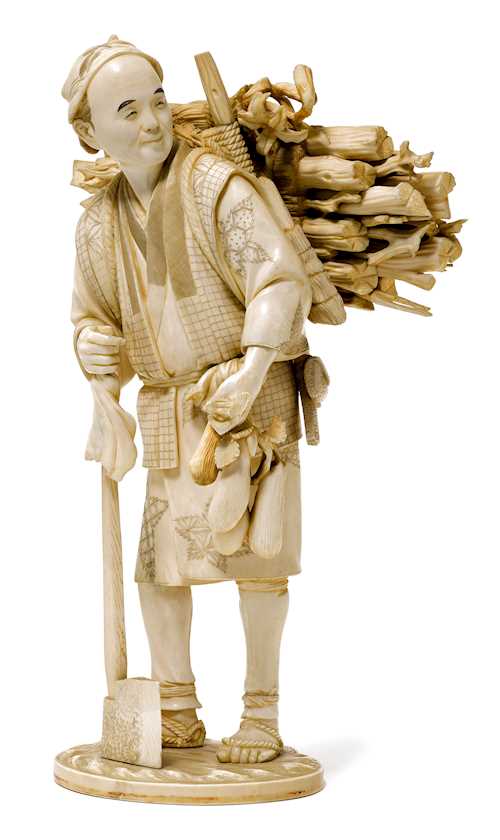 AN IVORY OKIMONO OF A PEASANT CARRYING WOOD.