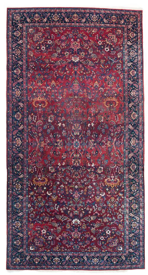 TABRIZ antique.Violet central field patterned throughout with floral motifs in shades of blue, dark blue edging with trailing flowers, 410x756 cm.