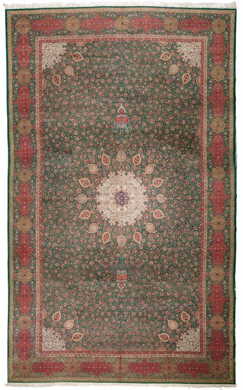 TABRIZ old.Green central field with a white central medallion, the entire carpet is finely patterned with trailing flowers and palmettes, green edging with red and yellow cartouches, in good condition, 470x760 cm.