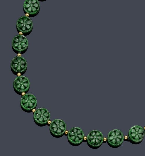 JADEITE AND GOLD NECKLACE. Clasp in yellow gold 750. Decorative necklace of 25 florally open-worked and finely engraved, round jadeites, Type A jade, with small gold beads as intermediate links. Total weight 44.53g. L ca. 44 cm. With Gübelin Report No. 0604021, April 2006.