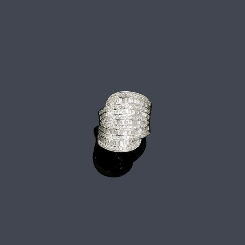 DIAMOND RING. White gold 750. Decorative, broad ring, the top with a row of 5 band motifs set throughout with numerous, baguette-cut diamonds, weighing ca. 2.30 ct in total, and brilliant-cut diamonds, weighing ca. 1.00 ct in total. Size ca. 54.