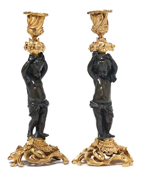 A PAIR OF CANDLESTICKS DESIGNED AS FIGURES