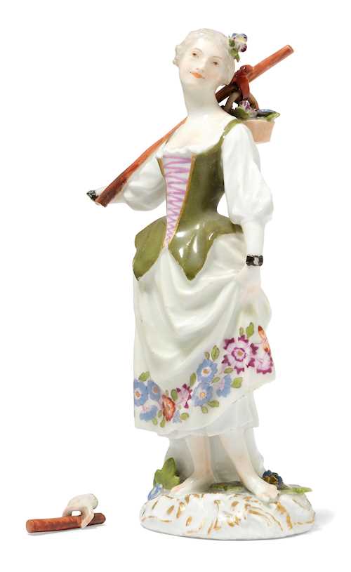 FIGURE OF A FEMALE GARDENER WITH A WALKING STICK