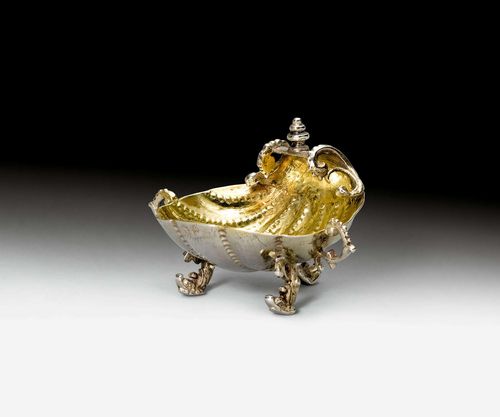 SALT CELLAR,Nuremberg ca. 1655. Maker's mark Oswald Haussner. Parcel-gilt. Fan-shaped vessel designed as a shell. On three volute feet. D ca. 5.5 cm, 30g. Provenance: German private collection.