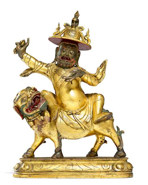 銅鎏金騎獅護法像。