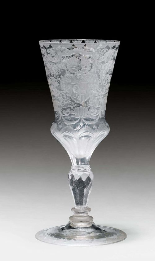 HUNTING GOBLET WITH FAMILY COAT-OF-ARMS,Bohemia, ca. 1770. Conical cuppa with facetted base over a facetted baluster shaft. The front with a coat-of-arms and crest with the initials 'EB C VS' and a hunting scene entitled 'jagen und hetzen thut mich ergetzen'. H 20.3 cm. Signs of a repair on the shaft.