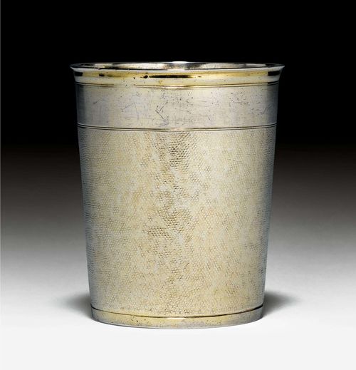 SNAKESKIN BEAKER,Augsburg 1st half of the 17th century.  Maker's mark IB. Slightly conical with profiled edge. Wall embossed all around. Bottom slightly retracted. Traces of gilding. H. 8 cm, 120g. Provenance: German private collection.