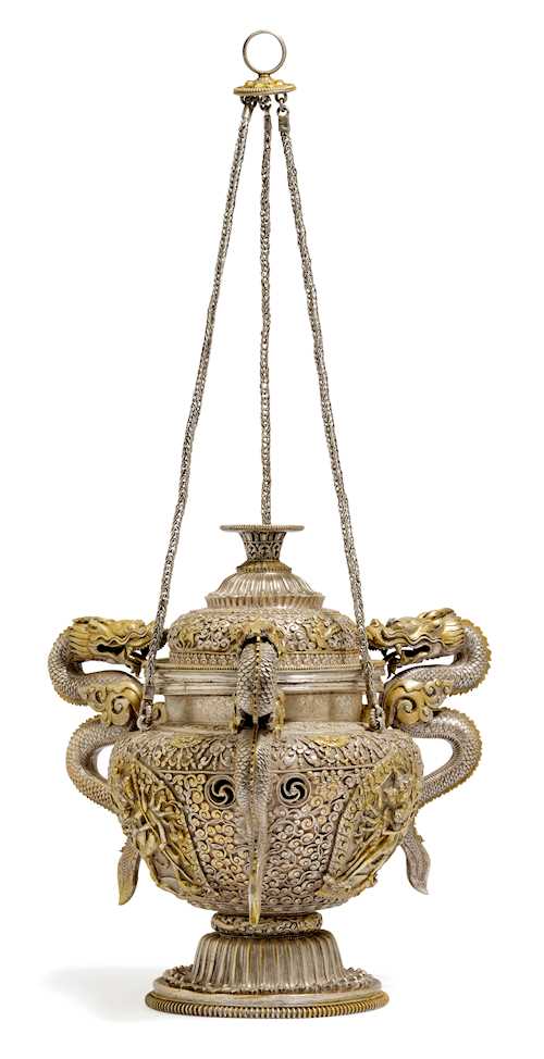 A HEAVY SILVER HANGING INCENSE BURNER WITH DRAGON HANDLES.