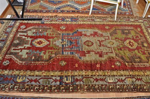 KAZAK old.Red ground with massive central medallion. The entire carpet with geometric pattern, gray border with stylized tendrils, slight traces of wear, 156x245 cm.