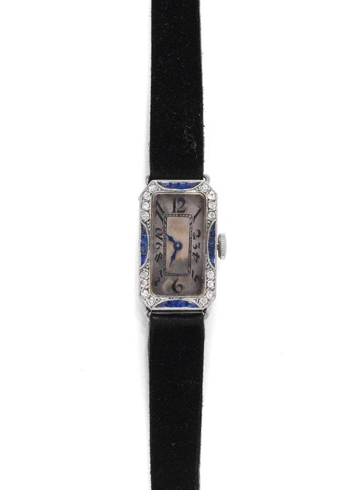 SAPPHIRE AND DIAMOND LADY'S WRISTWATCH, LONGINES, ca. 1925. Platinum. Octagonal case No. 3613887 with finely engraved sides and diamond-set lunette. Silver-coloured dial with Art Deco numerals and blued hands, unsigned, some patina. Hand winder, form movement, signed Longines No. 3613887, Breguet spring, bimetallic balance. Black velours band with steel clasp, not original. Does not run: resinified. D 22 x 14 mm.