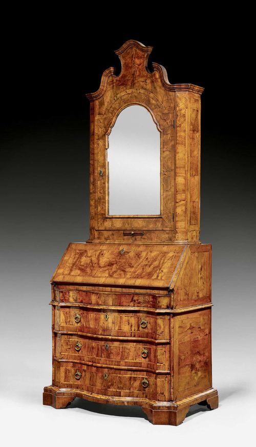 BUREAU CABINET, known as a "trumeau," Baroque, Veneto 18th century. Molded walnut and burlwood in veneer. Hinged writing surface above commode lower section with 3 drawers. Partly replaced, fitted interior with central door flanked on each side by 1 drawer below compartment. Secret compartment. The recessed upper section with one door with mirror. Bronze mounts and drop handles. Some losses. 88x51x(open 83)x229 cm.