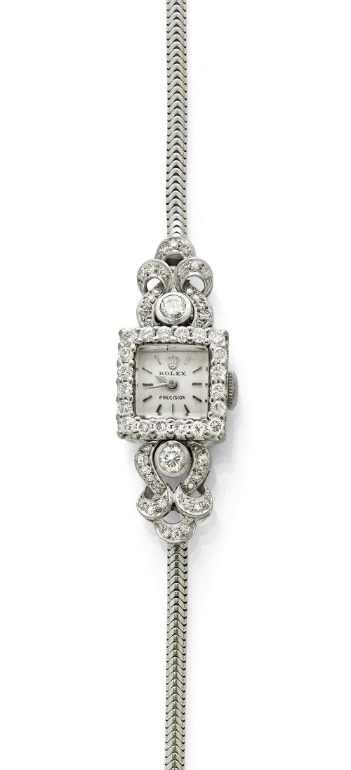 DIAMOND LADY'S WRISTWATCH, ROLEX, ca. 1950. White gold 750. Square case No. 1047 with brilliant-cut diamond lunette and attaches weighing ca. 1.00 ct. Silver-coloured dial, indices and hands, signed Rolex Precision. Hand winder, signed movement. Gold bracelet, not original, L ca. 15.5 cm. D 14 x 14 mm.