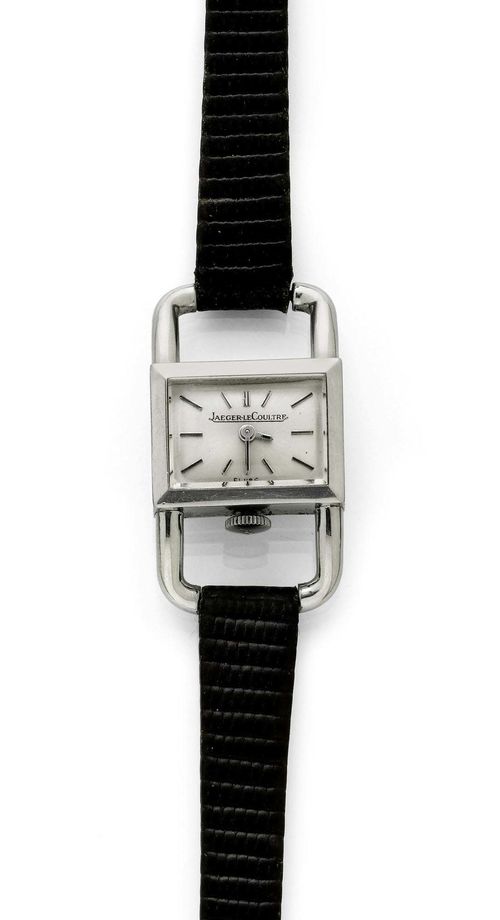 LADY'S WRISTWATCH, JAEGER LE COULTRE, 1980s. Steel. Ref. 1670.42, "Etrier" model. Rectangular case No. 1393985 with large, bow-shaped attaches. Winding crown at 6h. Silver-coloured dial, indices and hands, signed. Hand winder, Cal. 841, signed. Black leather band with original clasp. With case and warranty, April 1986.
