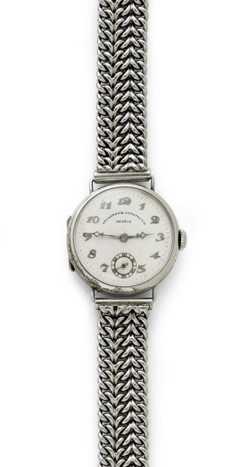 LADY'S WRISTWATCH, VACHERON & CONSTANTIN, ca. 1925. White gold 750, 39g. Round, polished case No. 258068 with gold wire attaches. Silver-coloured dial with applied Roman numerals and silver-coloured hands, small second. Lever movement No. 417615 with Breguet spring and bimetallic balance. White gold band, not original, L ca. 17 cm. D 24 mm.